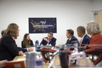 People sitting at board room table.